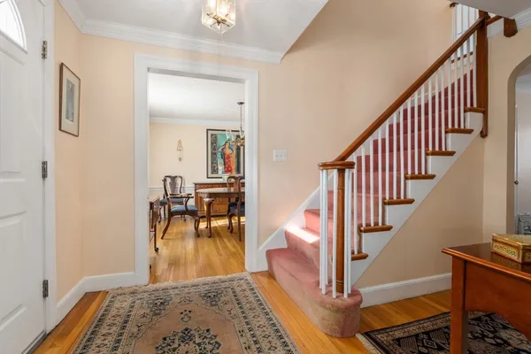 a view of a hallway with dining room and furniture
