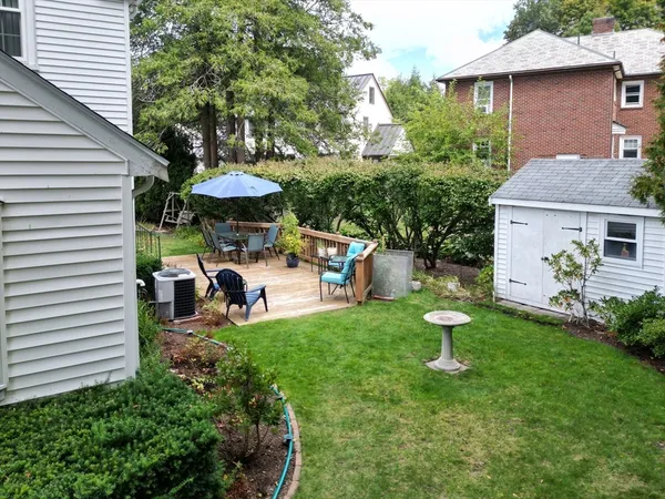 a view of a house with a yard fire pit and potted plants