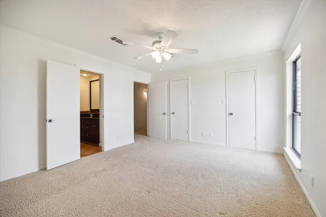 a view of a big room with closet and a chandelier fan