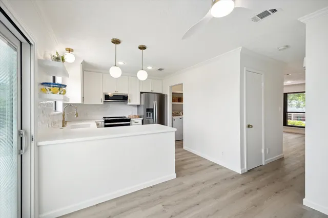 a kitchen with a sink a stove and refrigerator