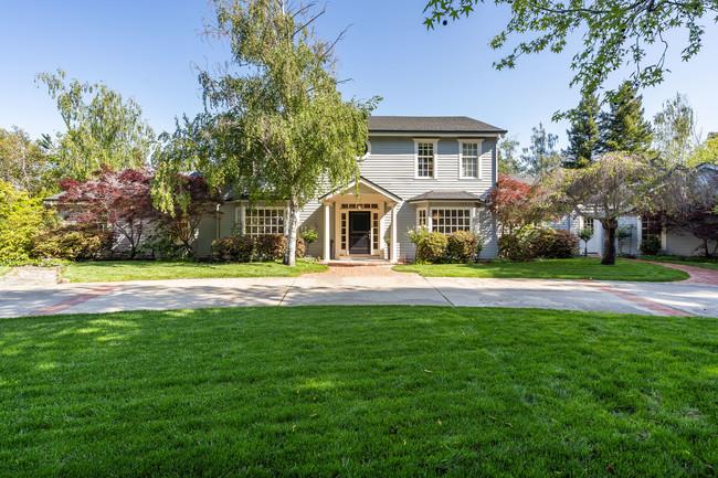 a front view of house with yard and green space