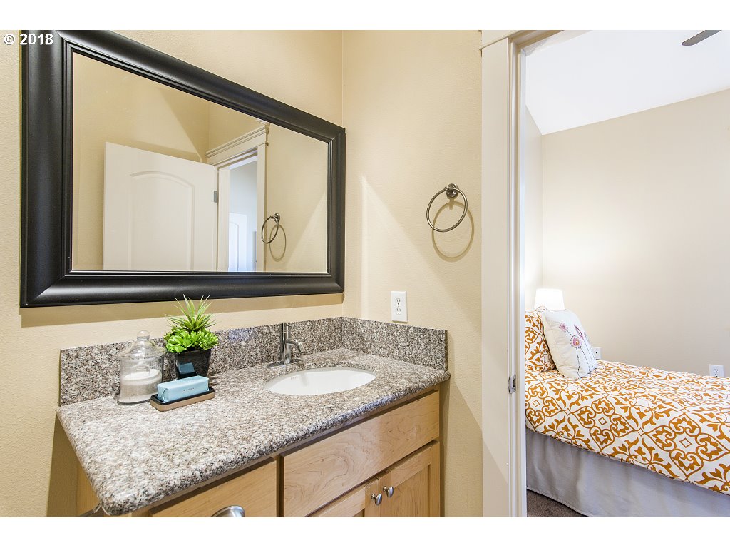 1126 Northeast 60th Avenue Portland, OR 97213 - Photo 16 of 25 a bathroom with a granite countertop sink and a mirror