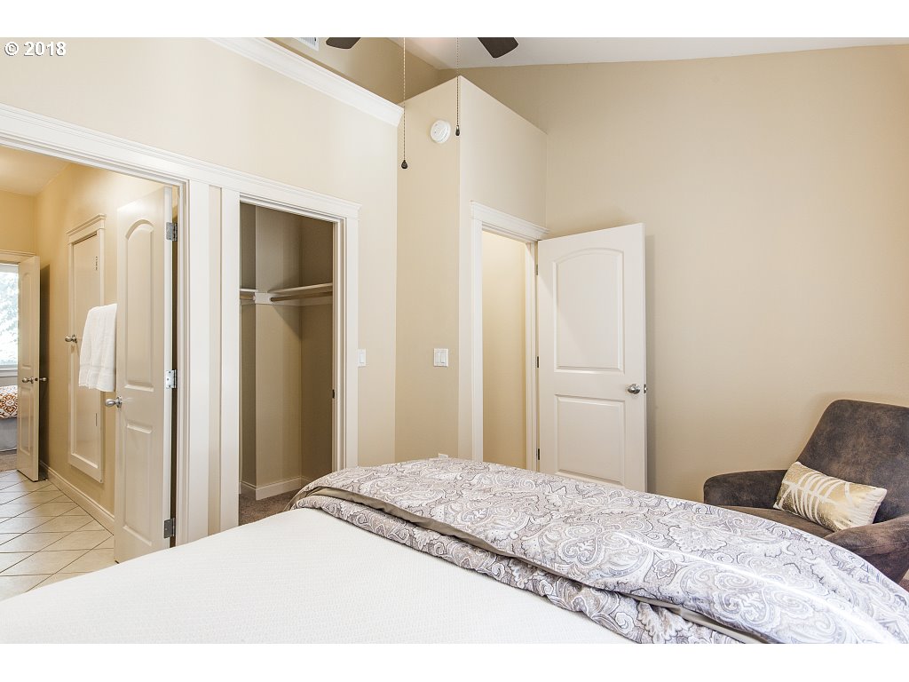 1126 Northeast 60th Avenue Portland, OR 97213 - Photo 22 of 25 a bedroom with a bed and a mirror