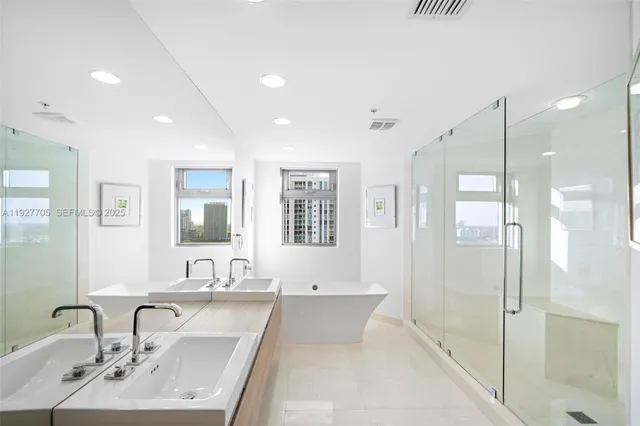 a bathroom with a sink tub and a mirror