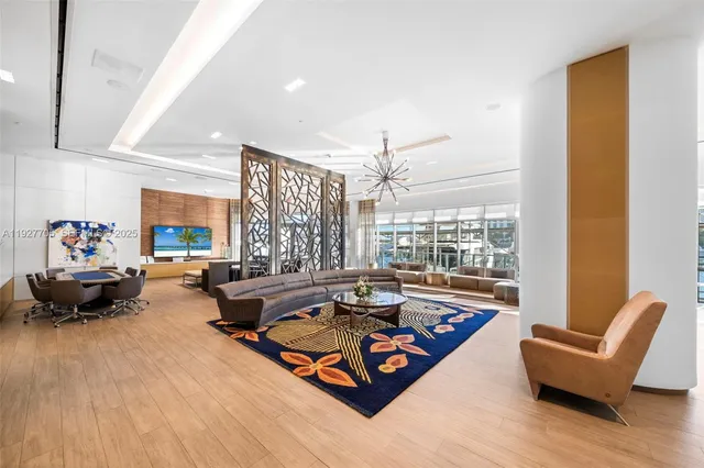 a living room with furniture and a floor to ceiling window