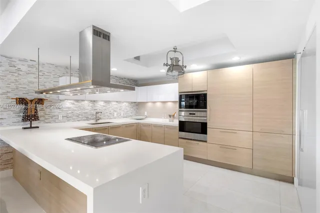 a kitchen with a sink a stove and oven