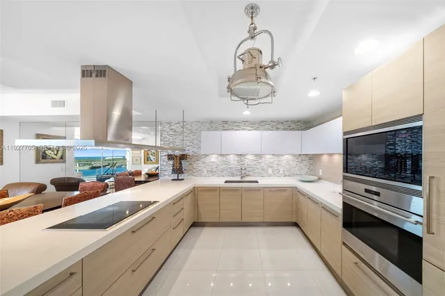 a large kitchen with a large counter top appliances and cabinets