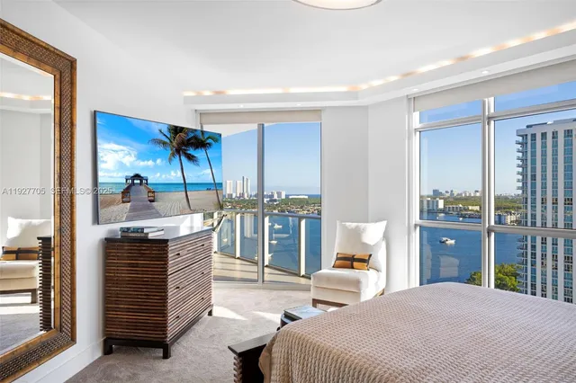 a bedroom with furniture and large window