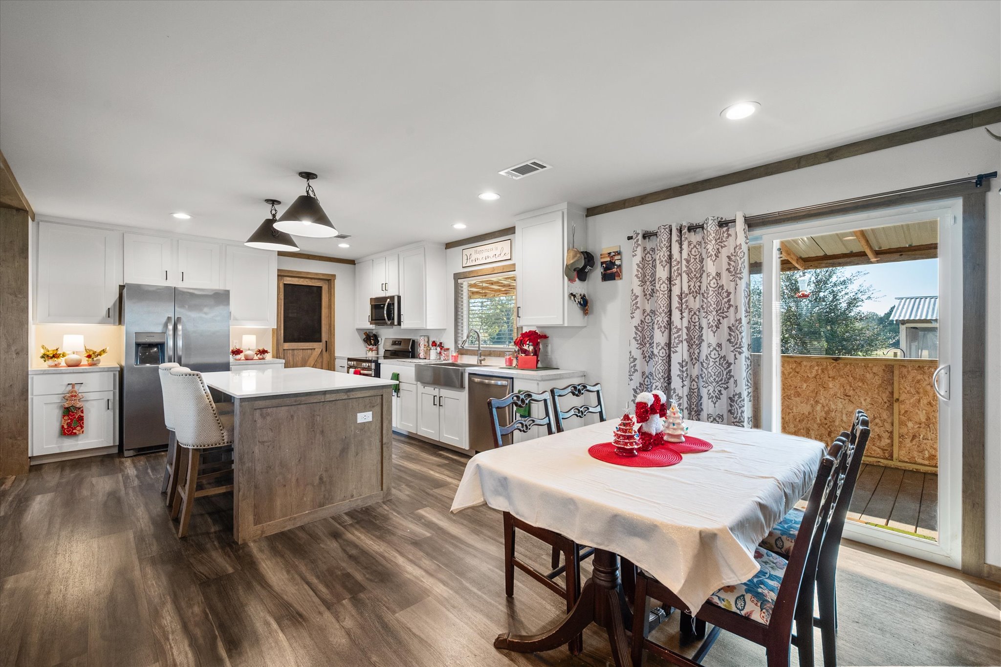 16857 Fm 639 Road East Purdon, TX 76679 - Photo 21 of 38 Kitchen with white cabinetry, appliances with stainless steel finishes, dark wood-style flooring, a center island, and recessed lighting
