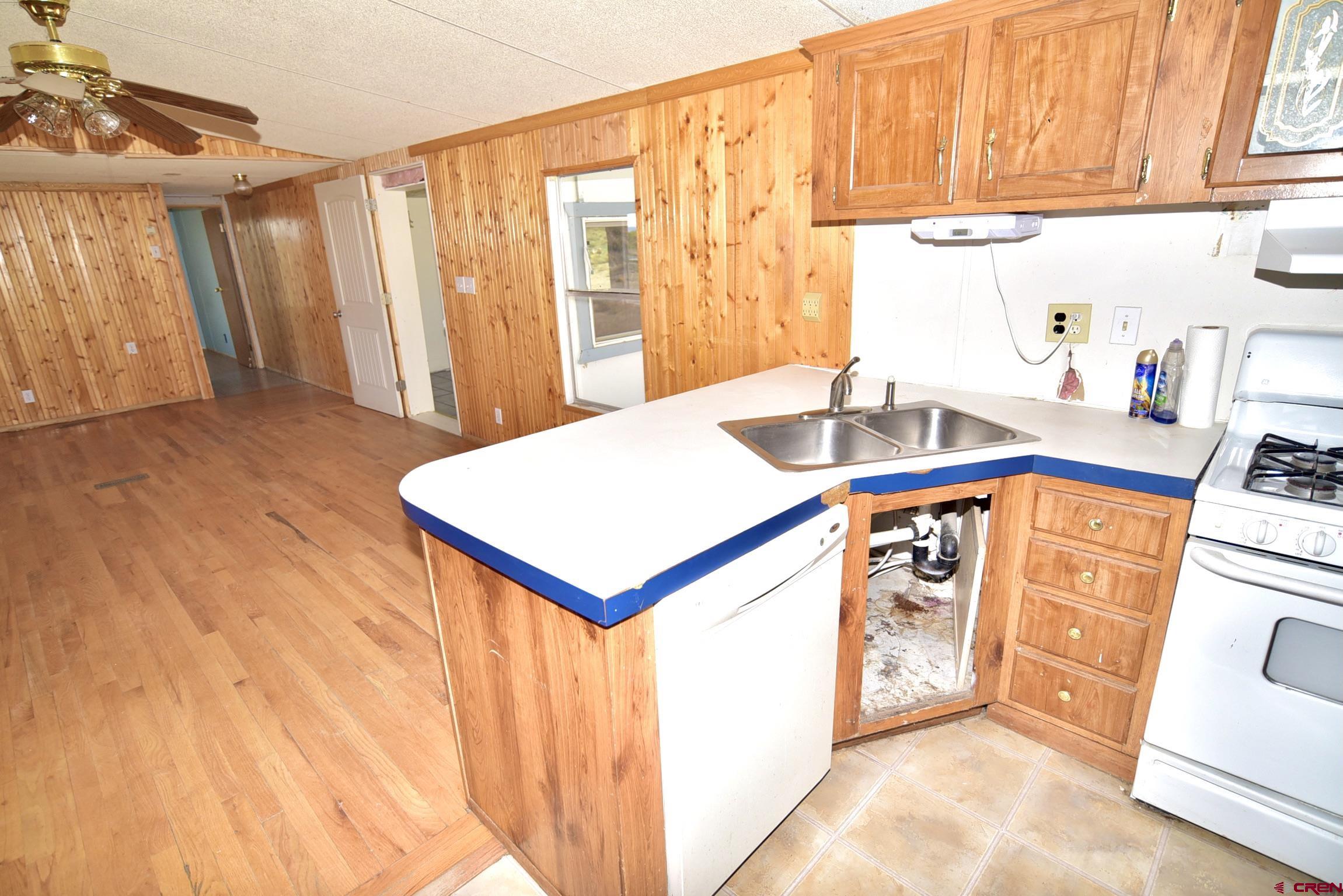 4499 Cedar Road Delta, CO 81416 - Photo 14 of 35 a kitchen with a sink a stove and a refrigerator