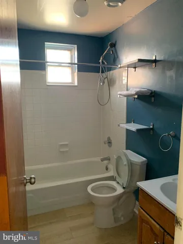 a bathroom with a toilet a sink and bathtub