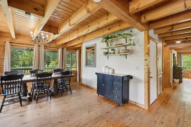 a bedroom with a bed a flat screen tv and a window