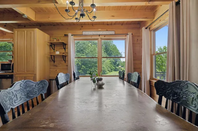 a living room with patio furniture and a wooden floor
