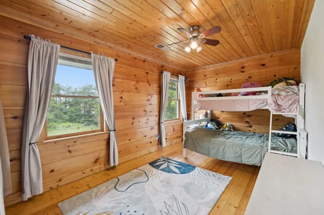 a front view of a house with a garden and swimming pool