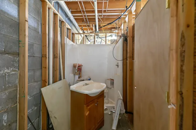 a yellow building with trees in the background