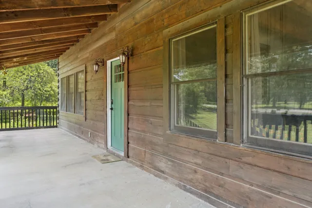 a view of a livingroom with furniture and staircase