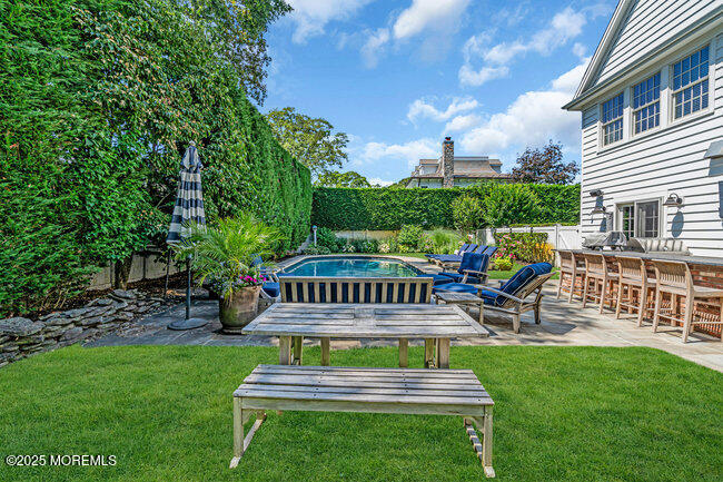 12 Red Oak Drive Spring Lake, NJ 07762 - Photo 12 of 79 a view of a chair and table in backyard of the house