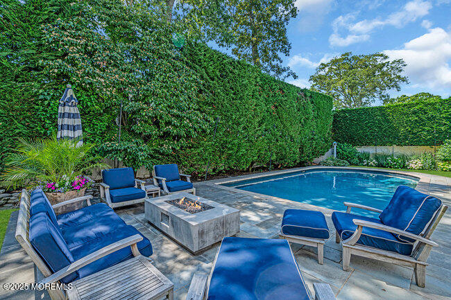 12 Red Oak Drive Spring Lake, NJ 07762 - Photo 14 of 79 a backyard of a house with table and chairs