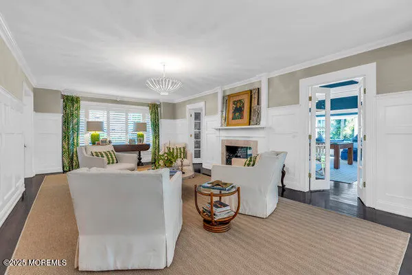 a living room with furniture a fireplace and a table