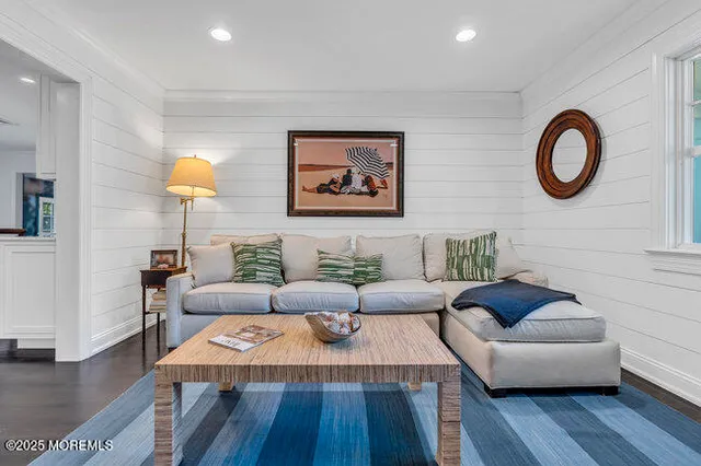 a living room with fireplace furniture and a wooden floor