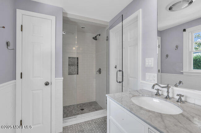 12 Red Oak Drive Spring Lake, NJ 07762 - Photo 74 of 79 a bathroom with a granite countertop sink a mirror and a shower