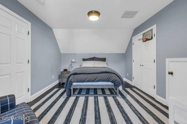 12 Red Oak Drive Spring Lake, NJ 07762 - Photo 75 of 79 a bedroom with a bed and wooden floor