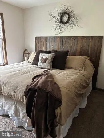 a large bed sitting in a bedroom next to a wooden cabinet