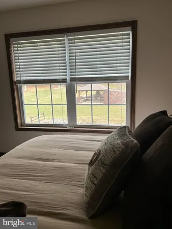 a bedroom with a bed with a window