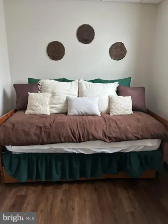 a view of a closet with wooden floor