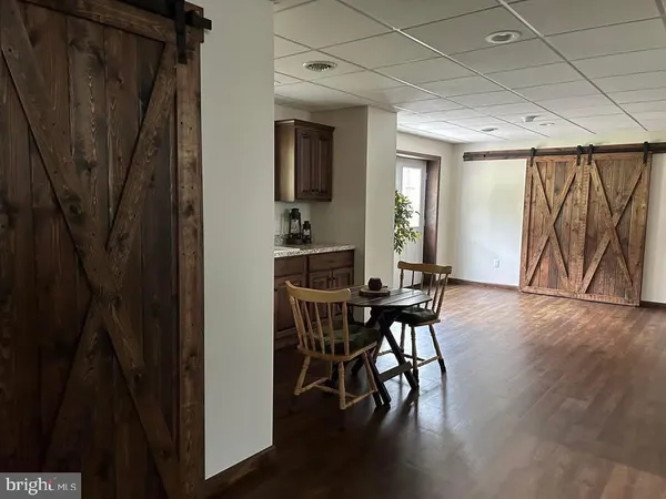 a view of a livingroom with a potted plant and a window