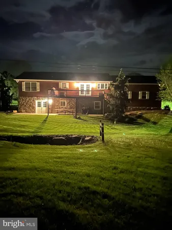a view of a house with a yard balcony and sitting area