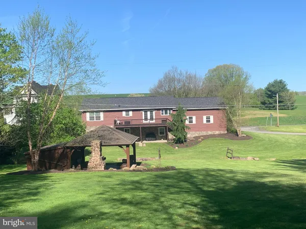 a kitchen with granite countertop a table chairs stove and cabinets