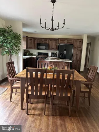 a view of a dining room with furniture and wooden floor