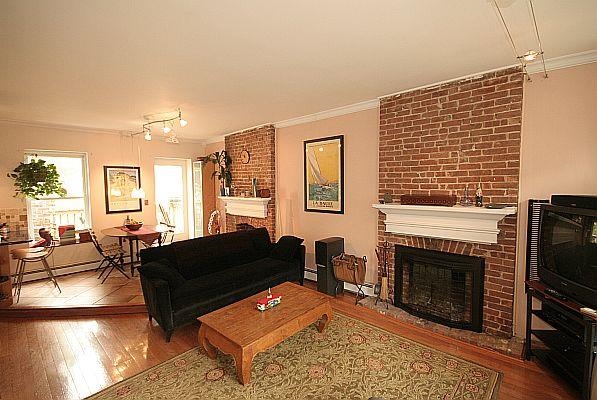 208 3rd Street Hoboken, NJ 07030 - Photo 1 of 22 a living room with furniture a fireplace and a flat screen tv