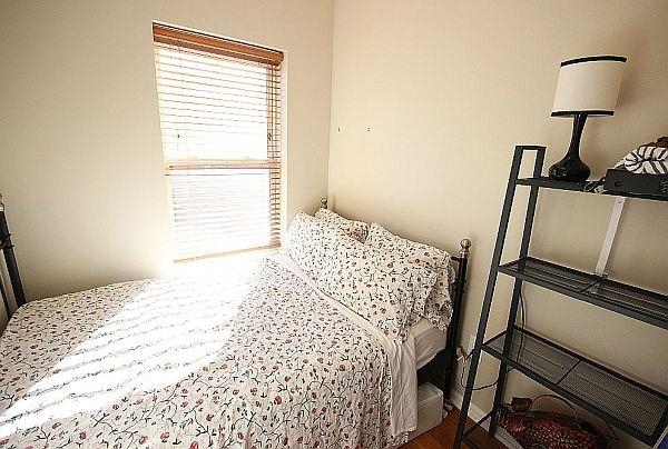 208 3rd Street Hoboken, NJ 07030 - Photo 11 of 22 a bedroom with a bed and a window