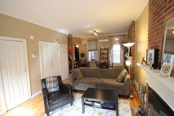 208 3rd Street Hoboken, NJ 07030 - Photo 13 of 22 a living room with furniture and a flat screen tv