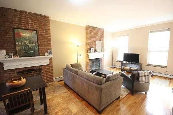 208 3rd Street Hoboken, NJ 07030 - Photo 14 of 22 a living room with furniture and a fireplace