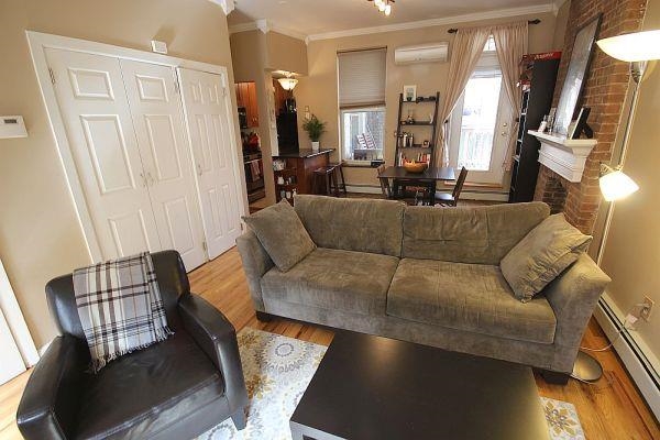 208 3rd Street Hoboken, NJ 07030 - Photo 16 of 22 a living room with furniture and a flat screen tv
