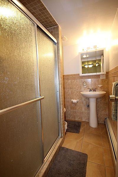 208 3rd Street Hoboken, NJ 07030 - Photo 20 of 22 a bathroom with a sink a toilet and shower
