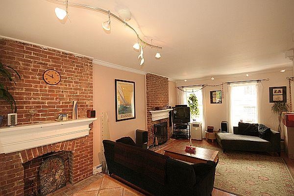 208 3rd Street Hoboken, NJ 07030 - Photo 2 of 22 a living room with furniture a fireplace and a flat screen tv