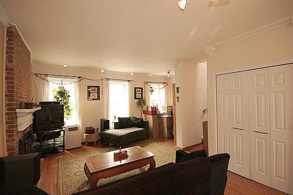 208 3rd Street Hoboken, NJ 07030 - Photo 4 of 22 a living room with furniture a flat screen tv and a window