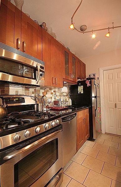 208 3rd Street Hoboken, NJ 07030 - Photo 6 of 22 a kitchen with stainless steel appliances and cabinets