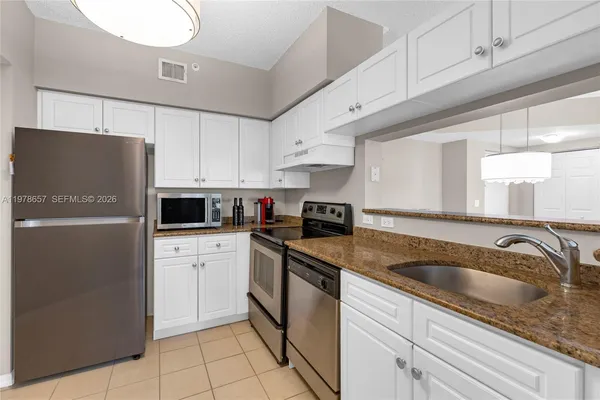 a view of a dining room with furniture wooden floor and chandelier