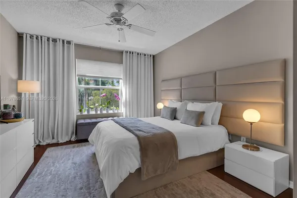 a bedroom with a large bed and a chandelier