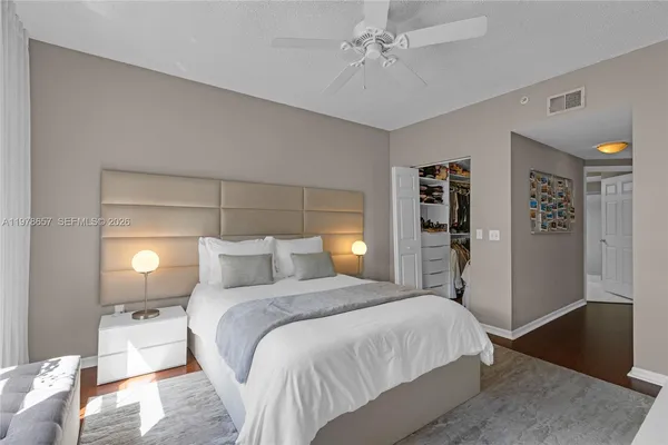 a spacious bedroom with a bed and a window