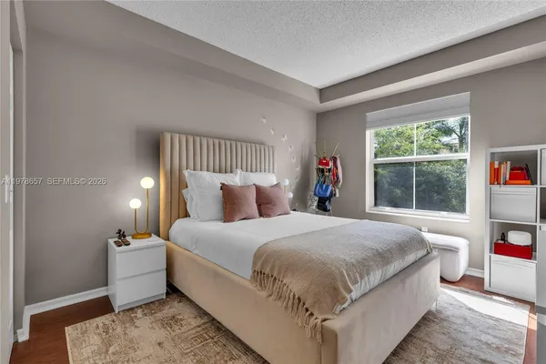 a spacious bedroom with a bed and a lamp