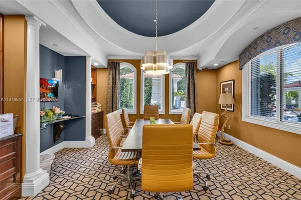 a dining room with granite countertop a table chairs and a kitchen view
