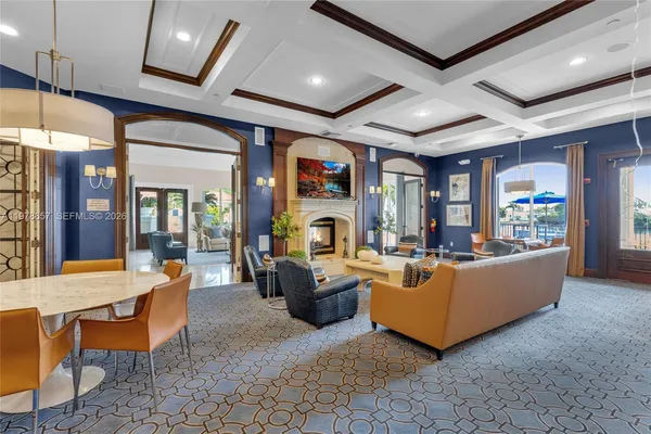 a living room with furniture a chandelier and a dining room