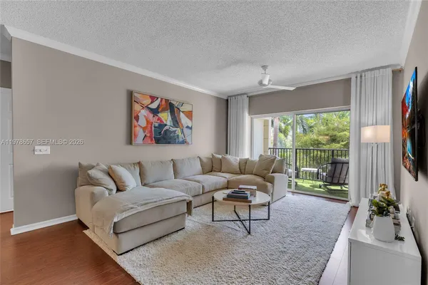 a living room with furniture kitchen view and a table