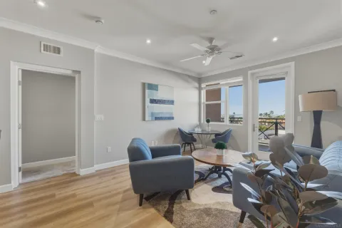 a living room with furniture and a wooden floor